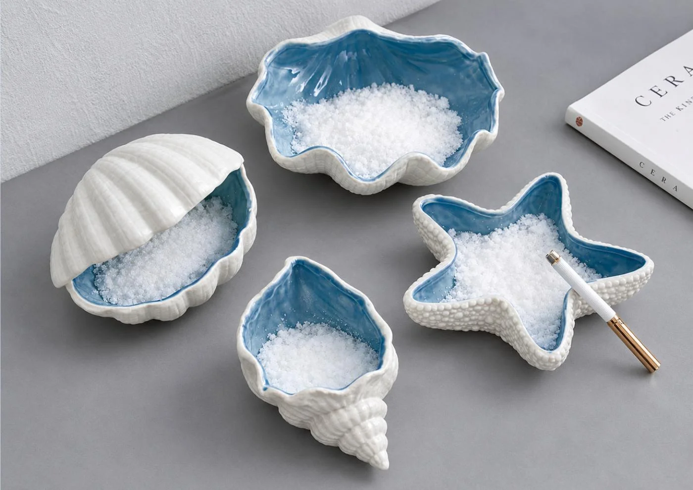 Presentation mockup of shell-shaped table accessories in blue and ivory